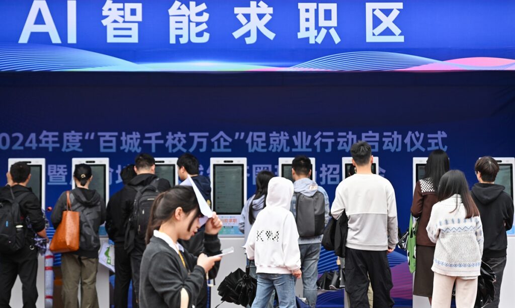 Students use artificial intelligent facilities to seek employment at a job fair at the Chongqing Technology and Business University in Southwest China